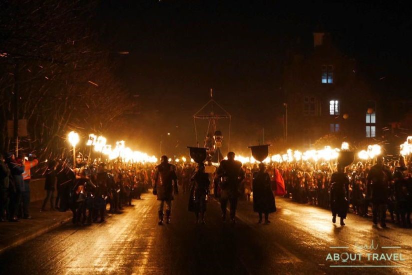 Parade of vikings holding torches during the Up Helly Aa festival